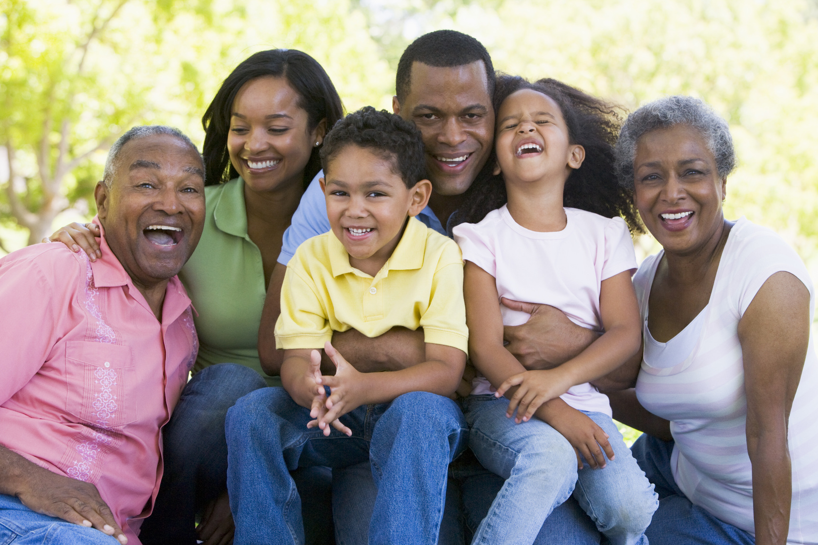 Extended family sitting outdoors smiling