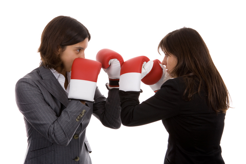 two businesswomen with boxing gloves fighting