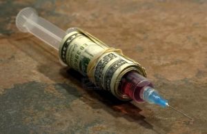 516052-photo-of-a-syringe-wrapped-with-money-addiction-concept