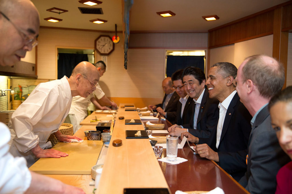 President Barack Obama and Prime Minister Shinzo Abe of Japan talk with sushi master Jiro Ono, owner of Sukiyabashi Jiro sushi restaurant, during a dinner in Tokyo, Japan, April 23, 2014. (Official White House Photo by Pete Souza) This official White House photograph is being made available only for publication by news organizations and/or for personal use printing by the subject(s) of the photograph. The photograph may not be manipulated in any way and may not be used in commercial or political materials, advertisements, emails, products, promotions that in any way suggests approval or endorsement of the President, the First Family, or the White House.